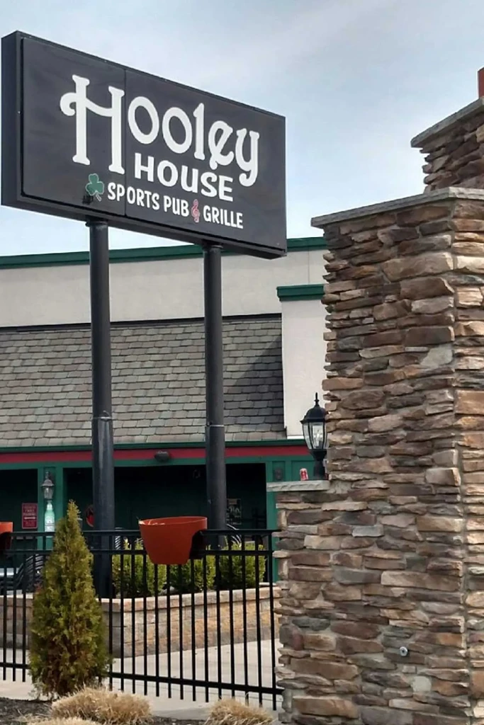 Black Hooley House Sports Pub & Grille sign, large stone pillar.