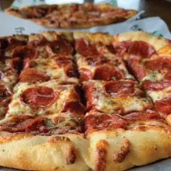 Two pizzas: rectangular pepperoni with square slices, and a round one.