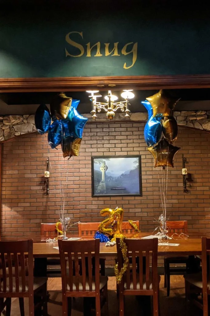 Cozy Snug restaurant interior with 21st birthday decorations.