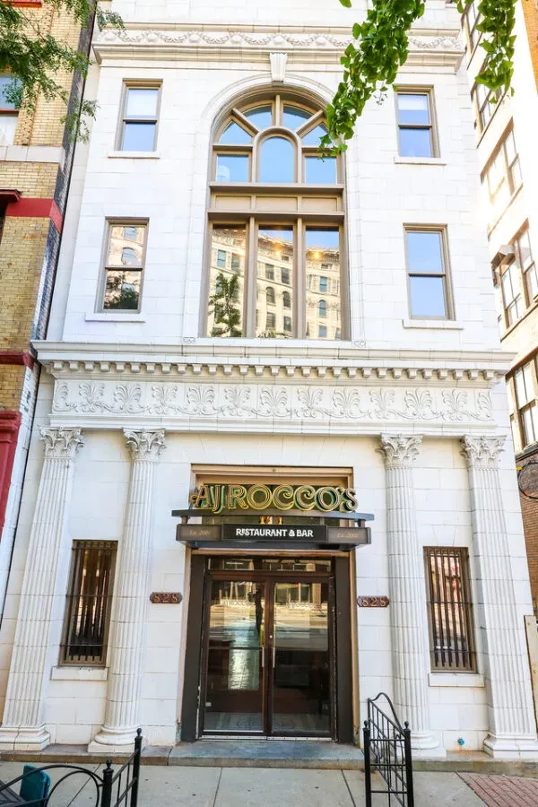 Classic stone facade of AJ ROCCO'S Restaurant and Bar entrance.