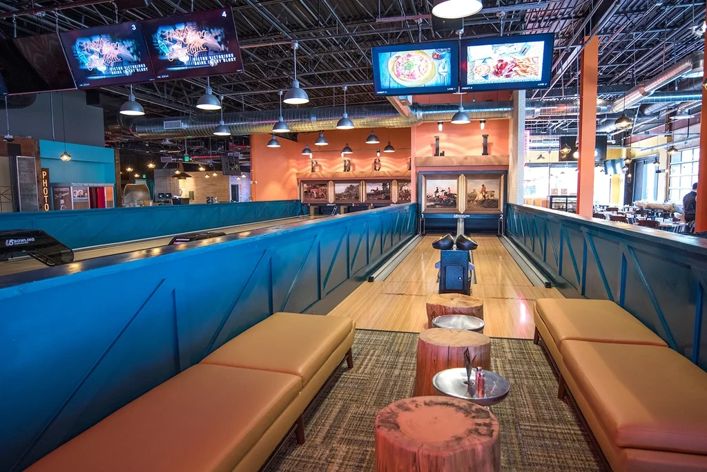 Modern venue with bowling lanes, restaurant, and bar.