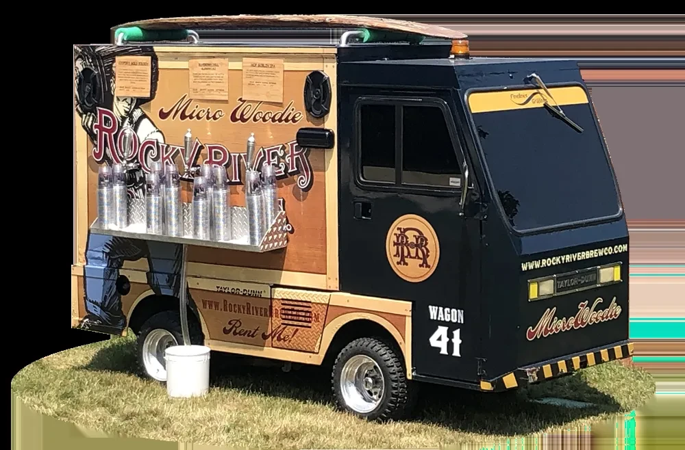 Retro Rocky River woodie beverage truck with taps and surfboard.