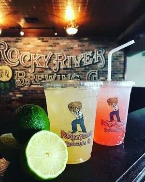 Yellow and red Rocky River Brewing drinks with fresh limes.