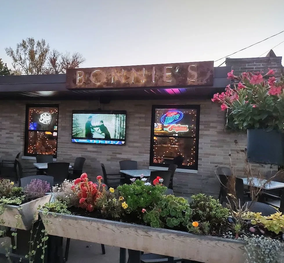 Bonnie's brick restaurant exterior at twilight with outdoor patio and lights.