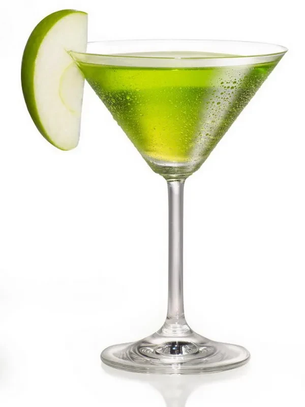 Vibrant green cocktail in martini glass with apple slice, white background.