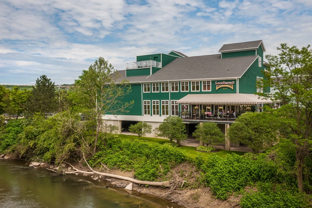 Lockkeepers restaurant, green with outdoor dining, beside a calm river.