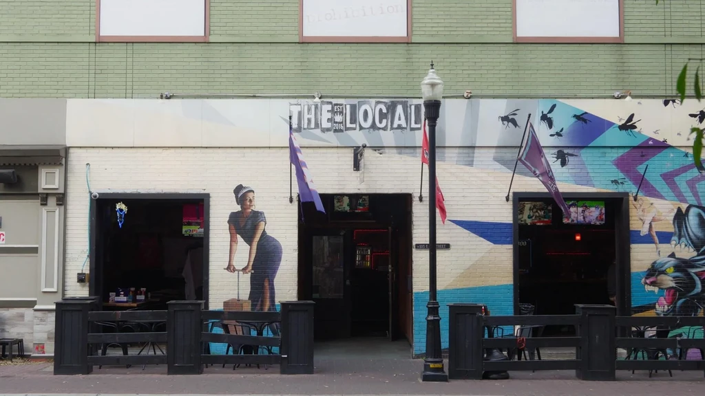 Restaurant 'THE LOCAL' exterior, multi-colored brick facade with extensive street art.