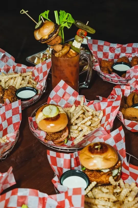 Overhead view of diner food and a heavily garnished Bloody Mary.