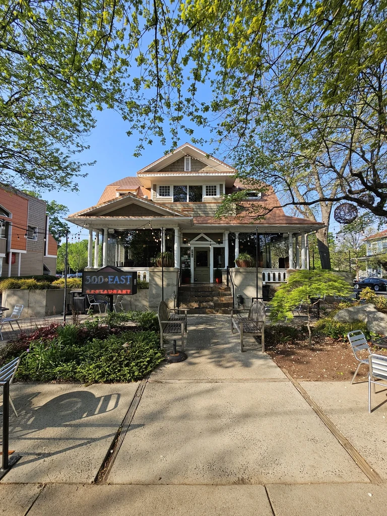 300 EAST RESTAURANT exterior: multi-story building with wide porch, sunny.