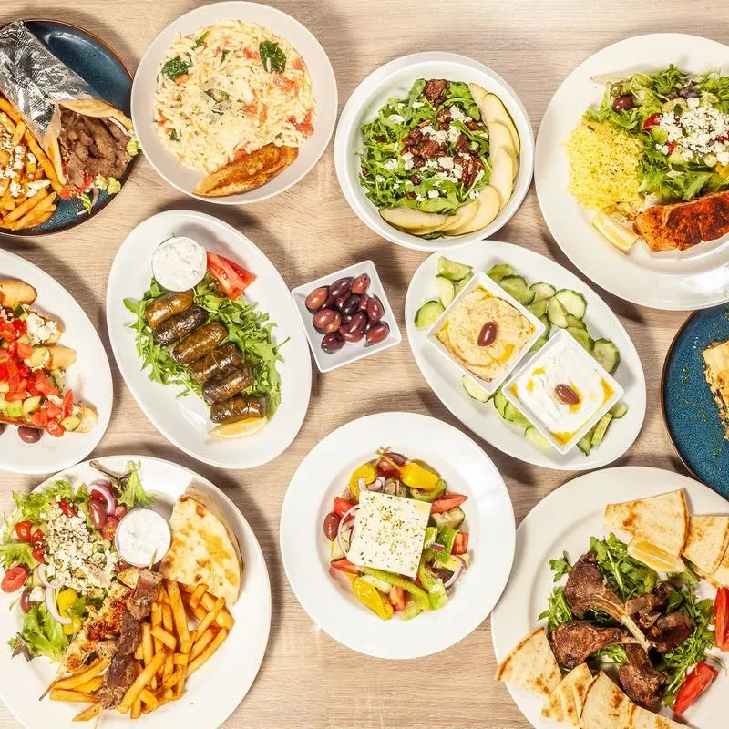 Vibrant overhead shot of a large assortment of Mediterranean dishes.