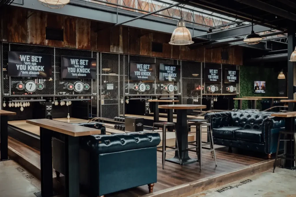 Industrial-style venue with mini-bowling lanes and lounge seating.