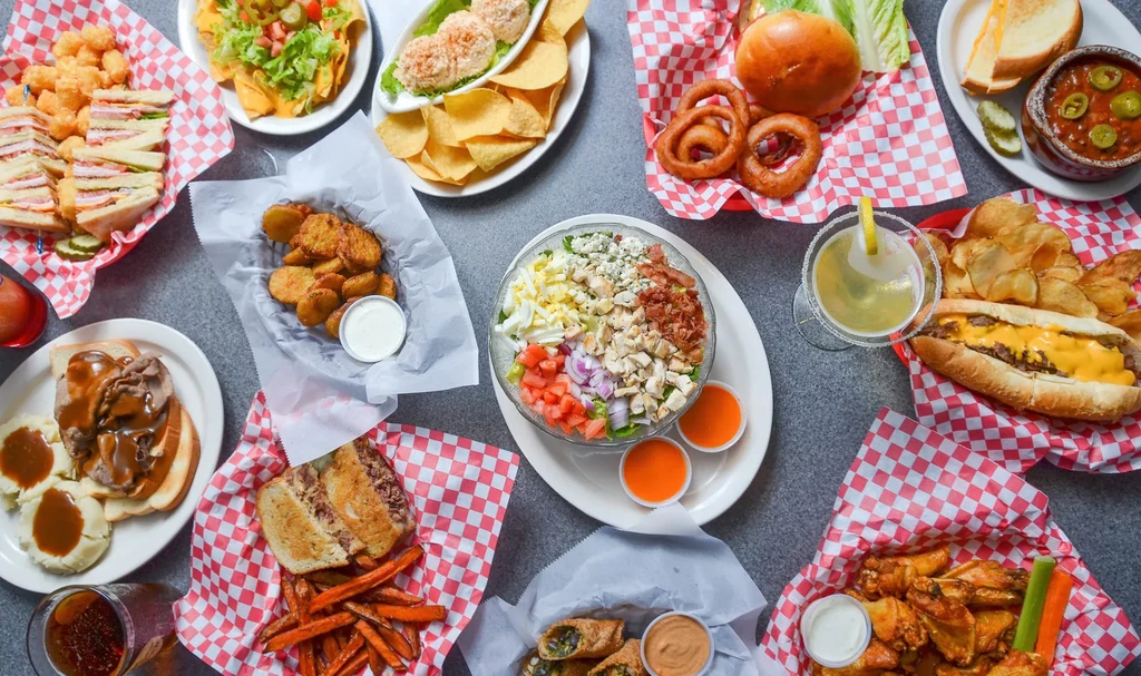 Overhead shot of a large spread of casual dining food items.