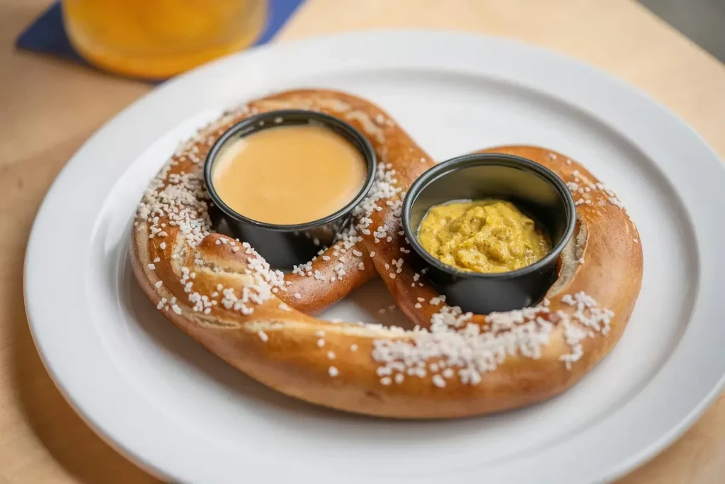 Salted golden pretzel with cheese and grainy mustard dips.