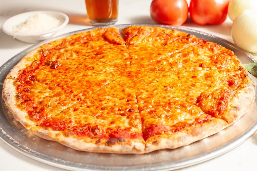 Freshly baked cheese pizza, bubbling and sliced, on a silver pan.