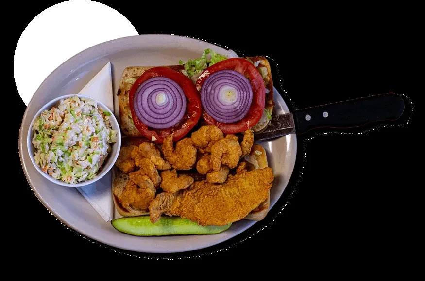 A fried shrimp and fish po'boy with lettuce, tomato, and sides.