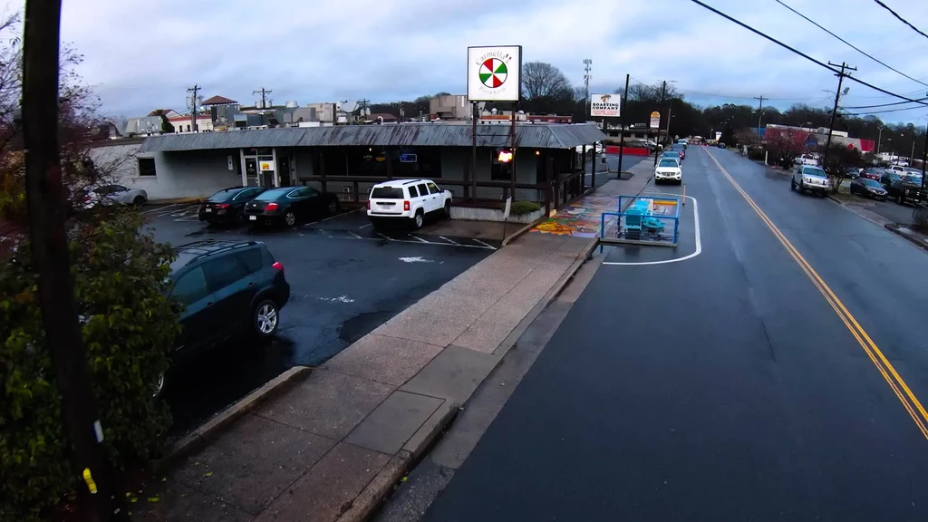 Exterior of Carmella's Pizza & Grill on a wet, overcast street.