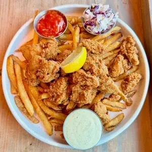 Fried chicken or seafood, french fries, coleslaw, lemon, and sauces.