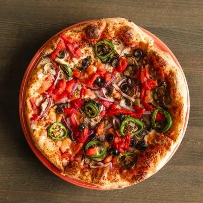 Whole vegetable pizza with peppers, olives, mushrooms, and onions.