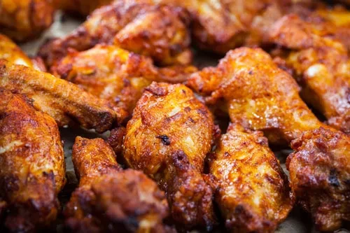 A pile of golden brown, seasoned, crispy cooked chicken.