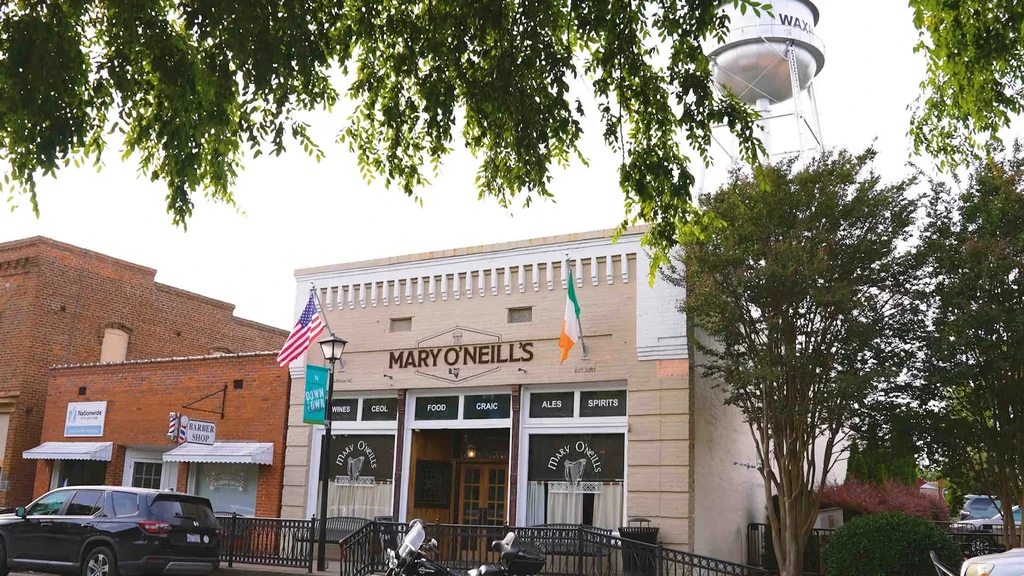 Mary O'Neill's Irish pub flies US and Irish flags under Waxhaw tower.