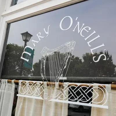 Mary O'Neill's Irish pub window display with harp and Celtic knots.