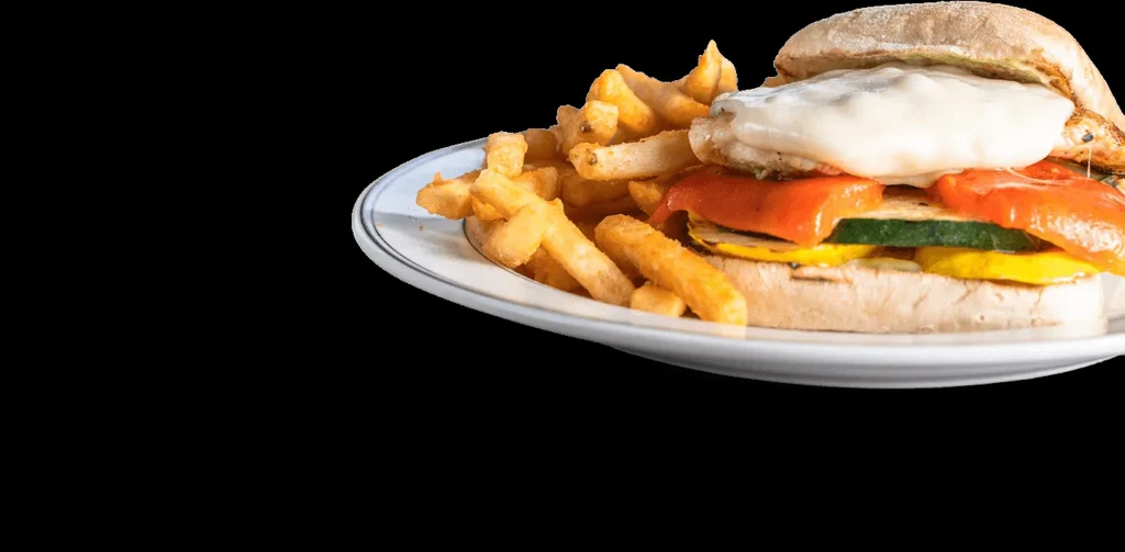 Grilled vegetable sandwich with melted cheese and french fries.