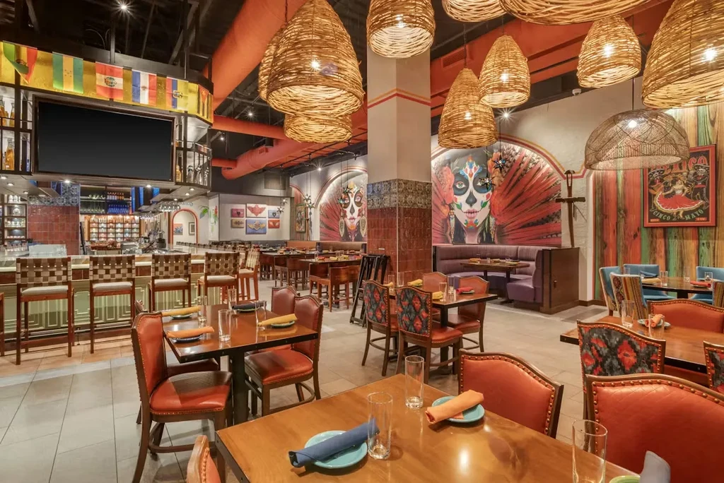 Colorful, vibrant Mexican restaurant interior with dining and bar.