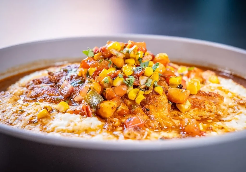 Creamy polenta with sauced protein and colorful tomato-corn salsa.