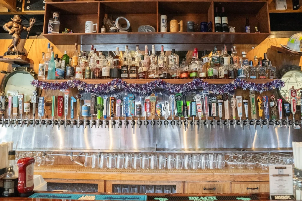 A well-stocked bar with 40 beer taps, spirits, and a devil statue.