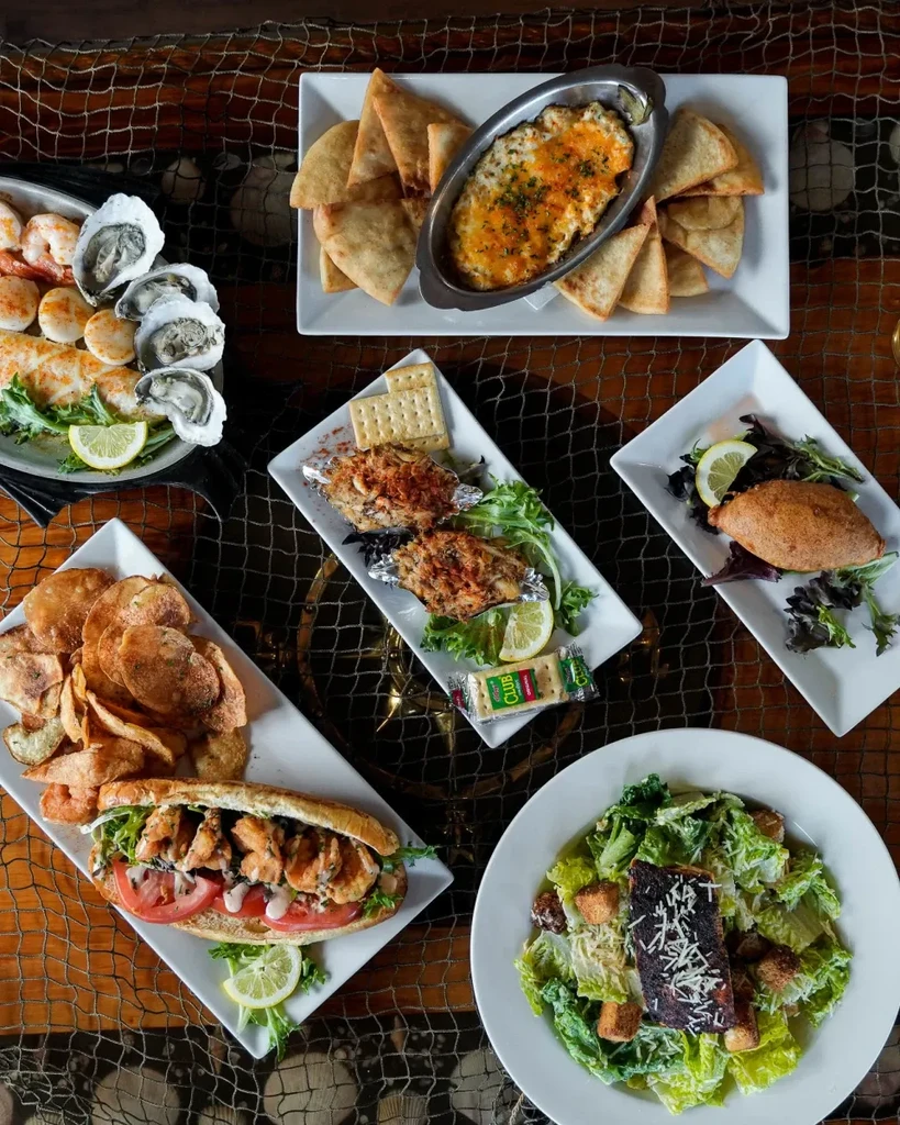Rustic table laden with a bountiful spread of diverse seafood dishes.