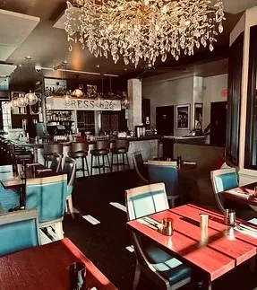 Ornate crystal chandelier, red tables, and "PRESS 626" restaurant bar.