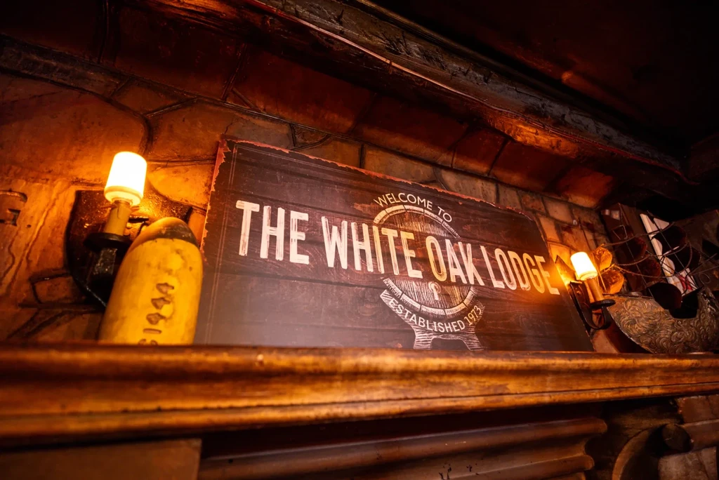 Illuminated rustic wooden sign for "White Oak Lodge Est. 1973".