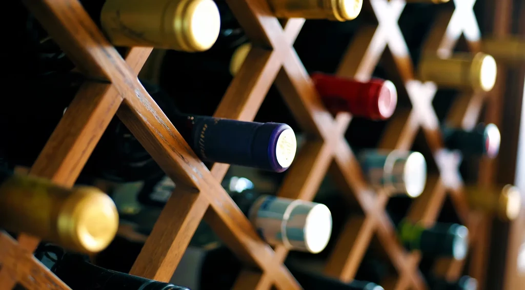 Close-up of a purple-capped bottle in a horizontal diamond wine rack.