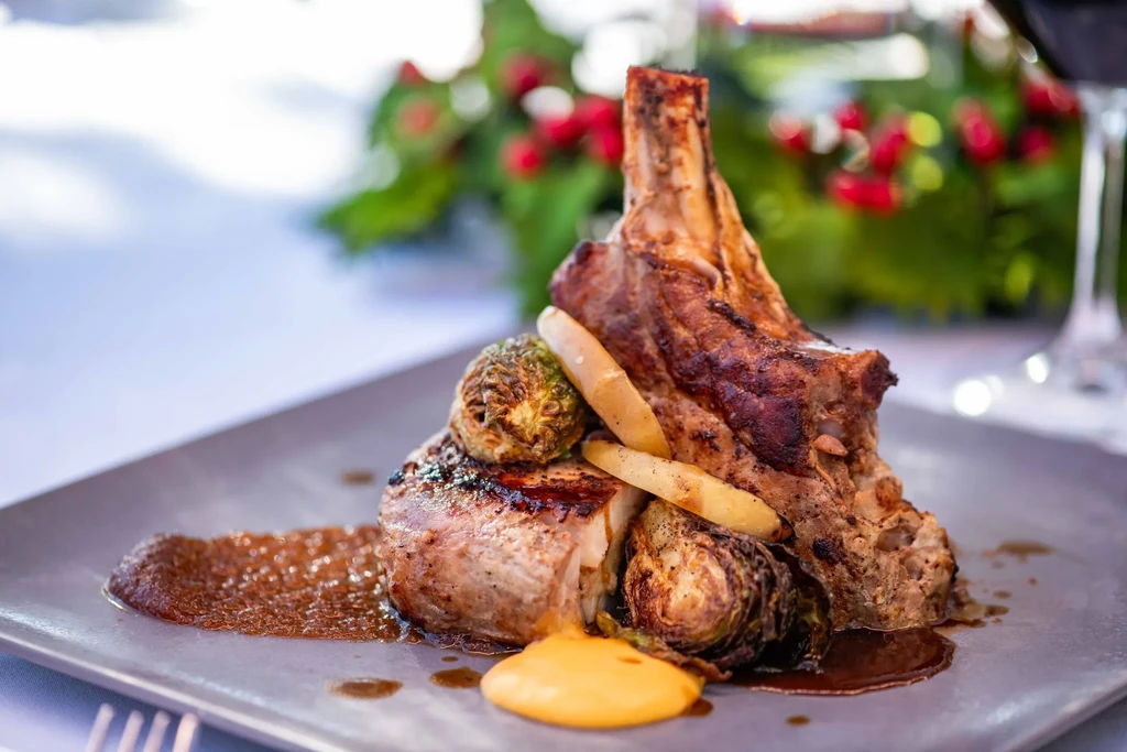 Seared bone-in chop, roasted Brussels sprouts, parsnips, dark and yellow sauces.
