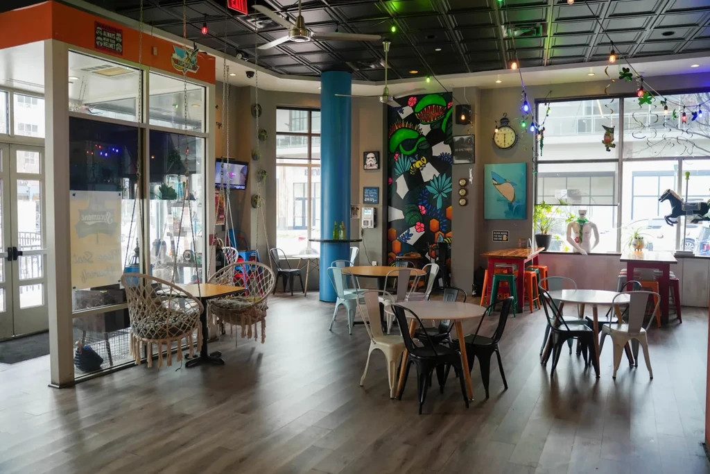 Lively, eclectic restaurant interior with colorful mural and unique decor.
