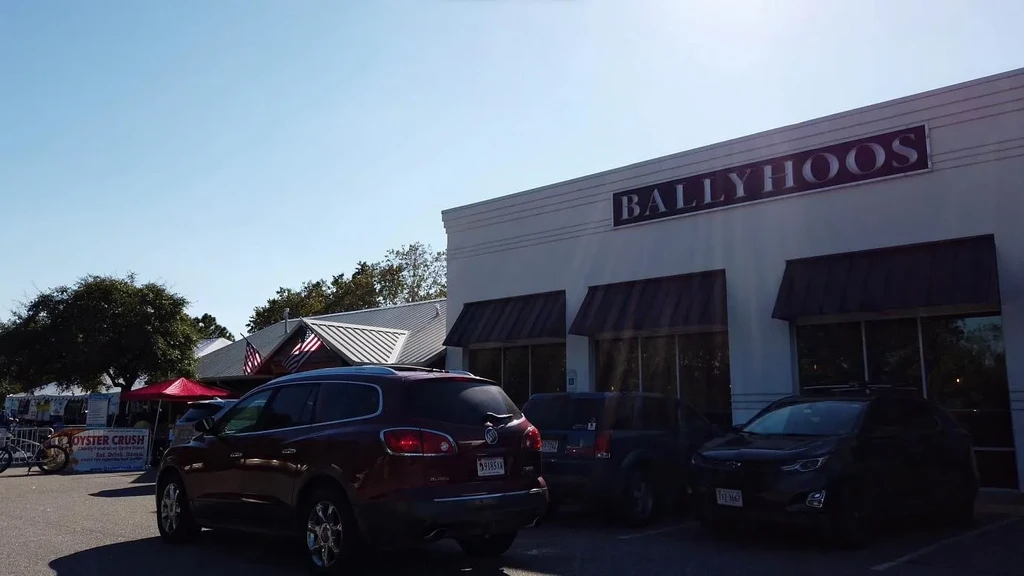 BALLYHOOS restaurant exterior, sunny day, with 'OYSTER CRUSH' event tent.