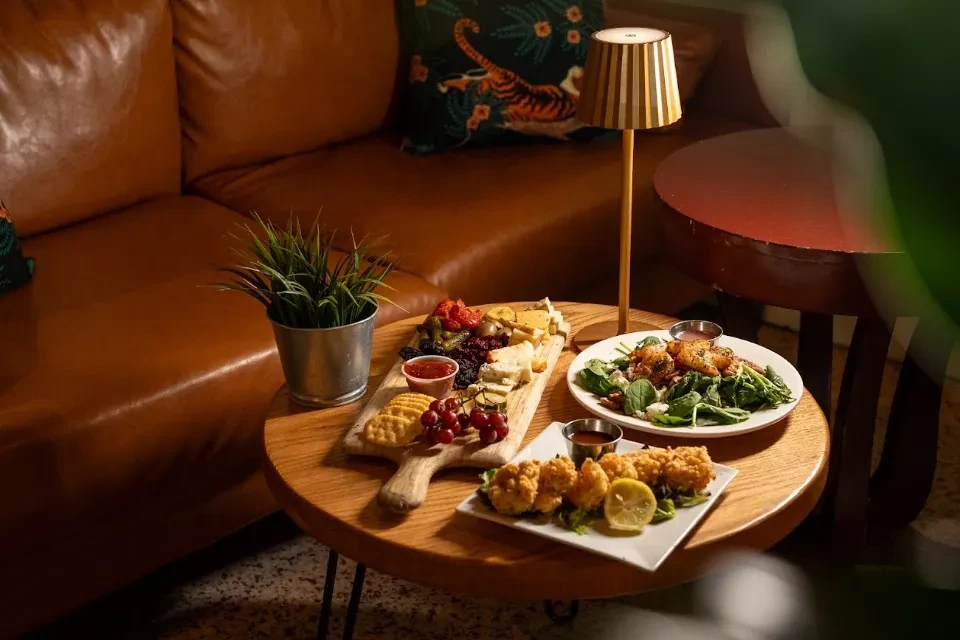 Restaurant table with charcuterie, green salad, and fried appetizers.