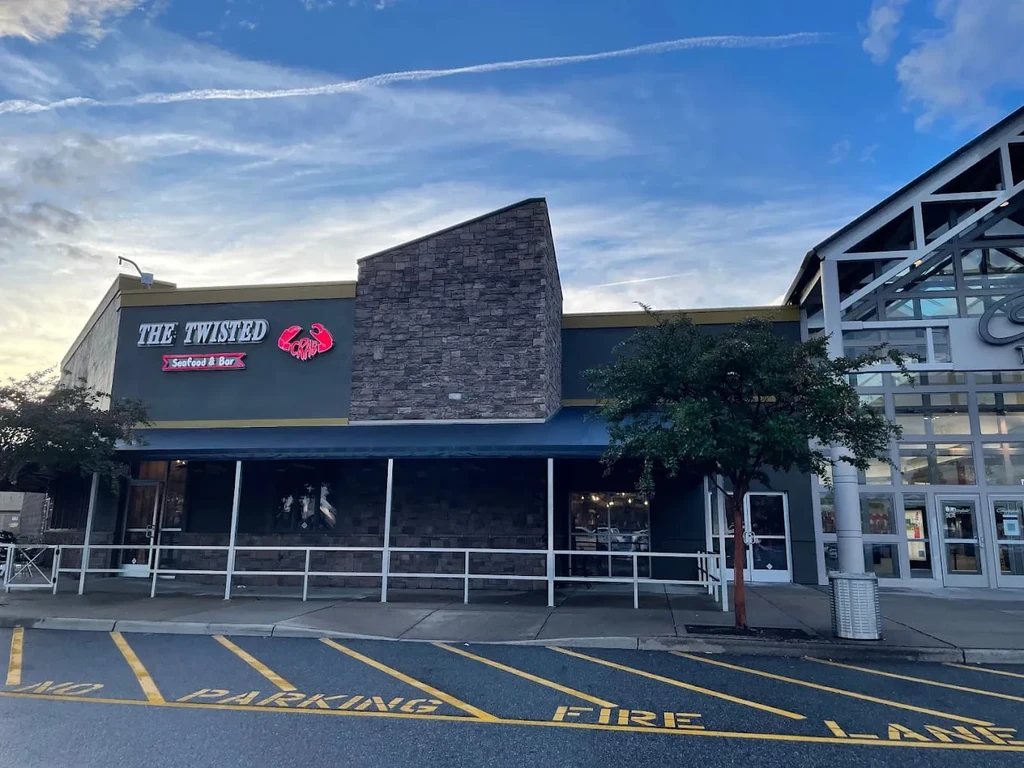 Exterior of The Twisted Crab restaurant with a red crab logo and fire lane.