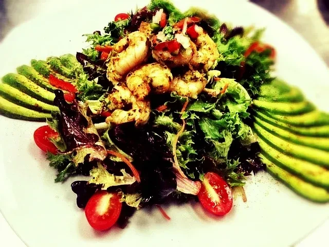 Seasoned shrimp salad with avocado, mixed greens, and cherry tomatoes.