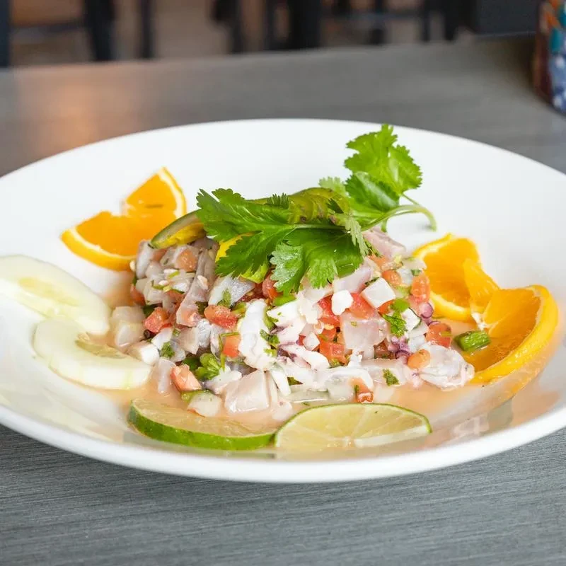 Diced seafood salad or ceviche, garnished with citrus and cilantro.