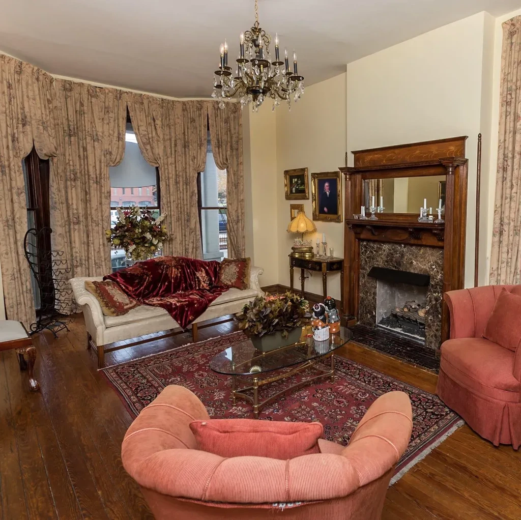 Luxurious classic living room with ornate fireplace and crystal chandelier.