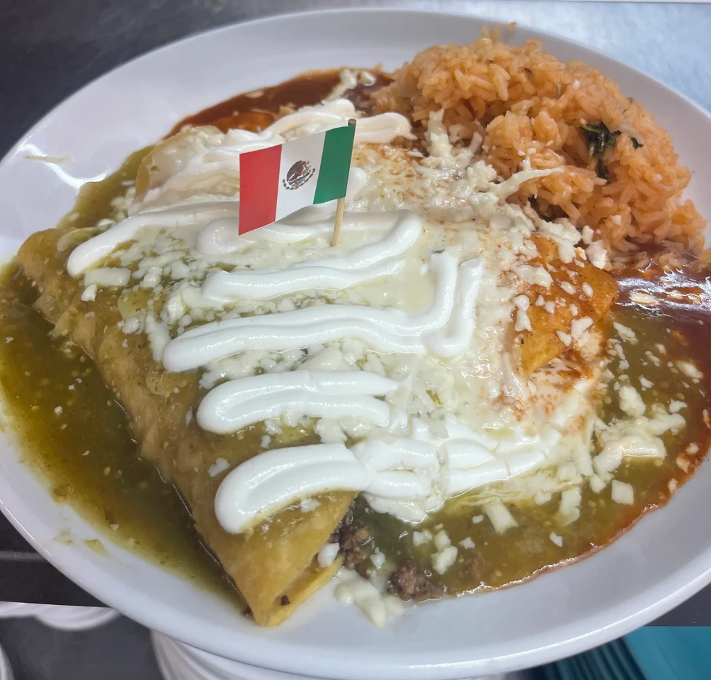 Enchiladas with green and red sauce, cheese, rice, and Mexican flag.