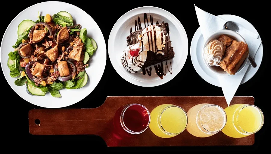 Flat lay of salad, brownie, pudding, and a five-drink flight.