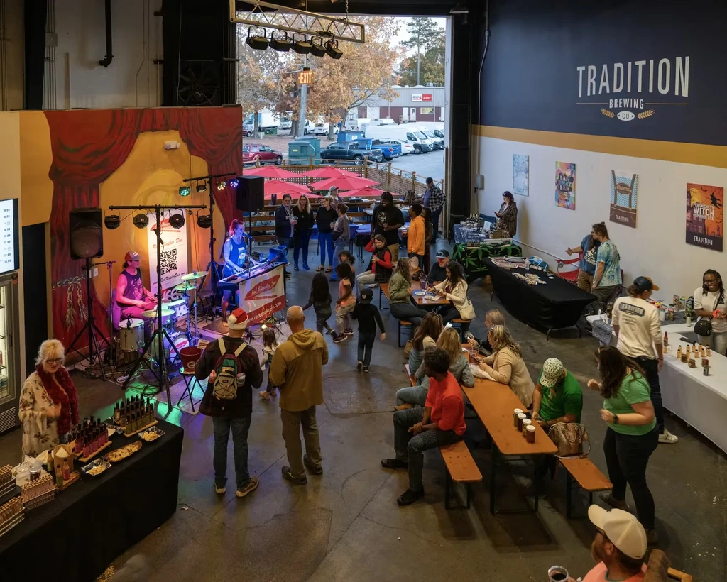 Lively indoor-outdoor brewery event at Tradition Brewing Co. with live band.