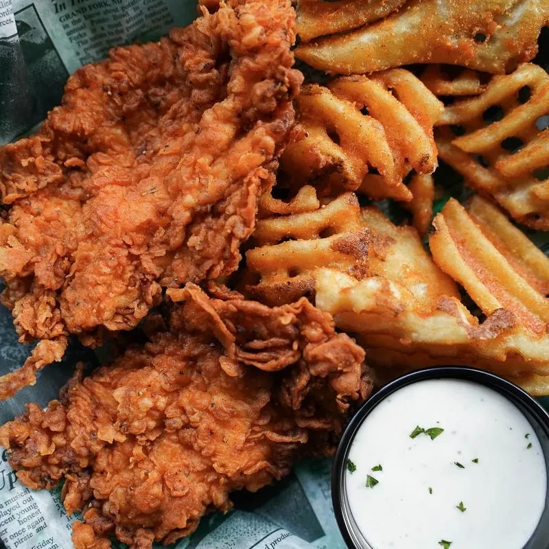 Crispy fried chicken, golden waffle fries, and herbed dipping sauce.