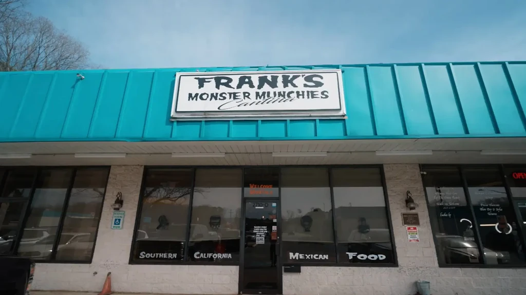 Frank's Monster Munchies Cantina exterior with turquoise roof and brick facade.