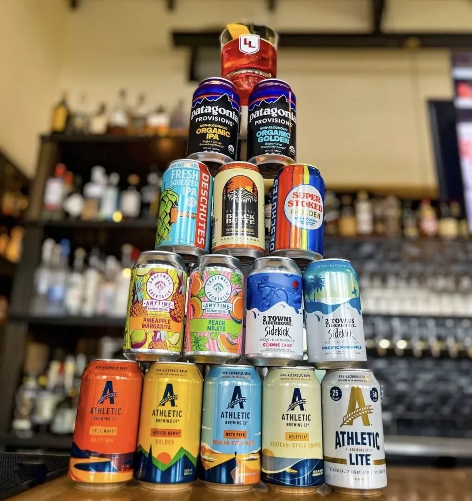 Vibrant pyramid stack of non-alcoholic beers and craft cocktails.