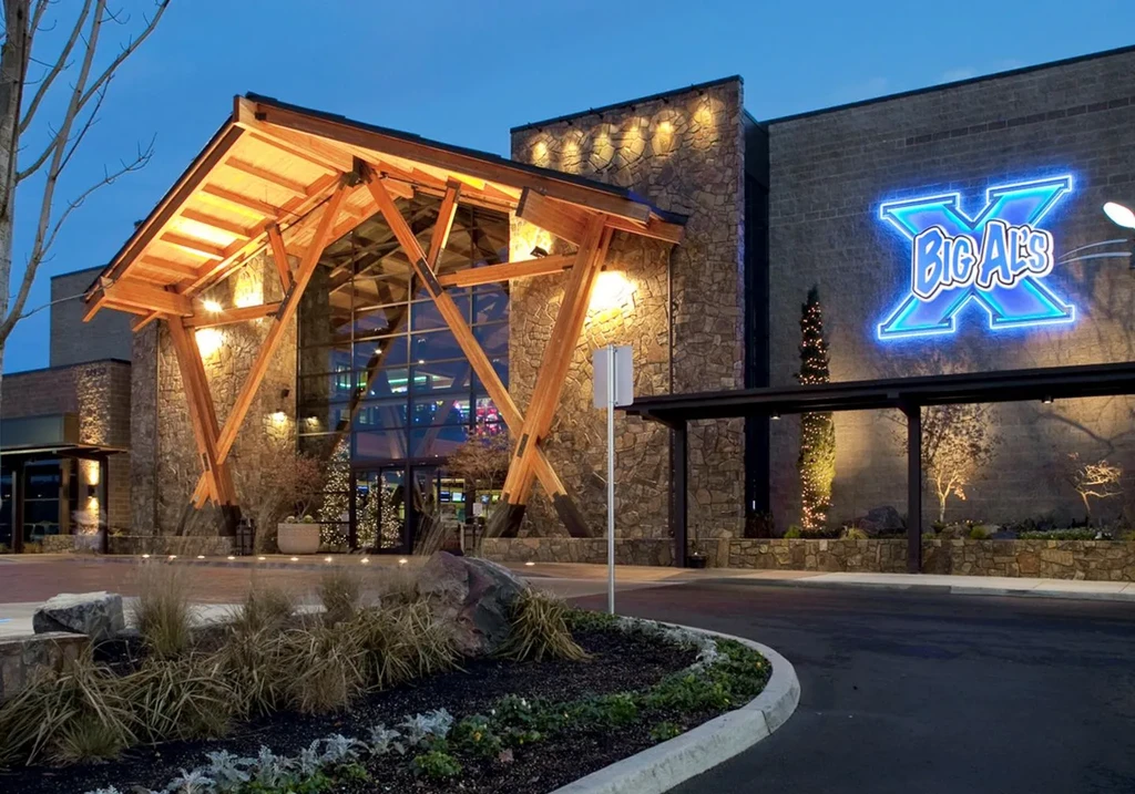 Modern Big Al's building, A-frame entrance, and neon sign at night.