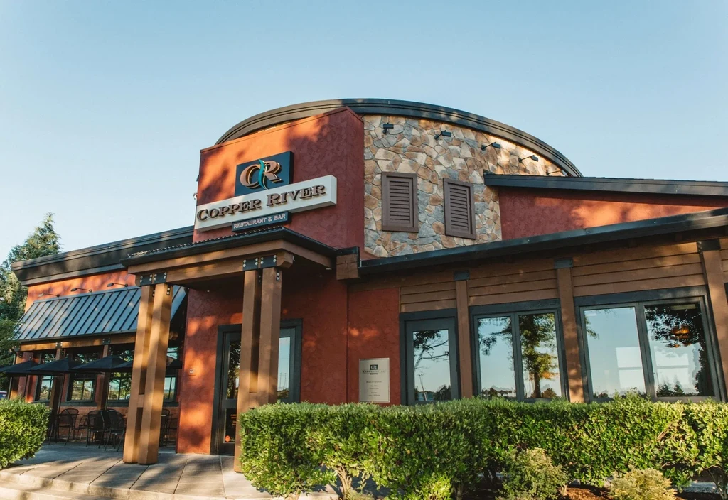 Copper River Restaurant & Bar exterior with multi-textured facade and patio.