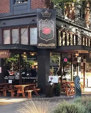 Hotel Corvallis Pub & Eatery building with outdoor picnic tables.